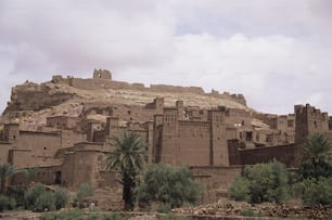 a large brown building sitting on top of a hill