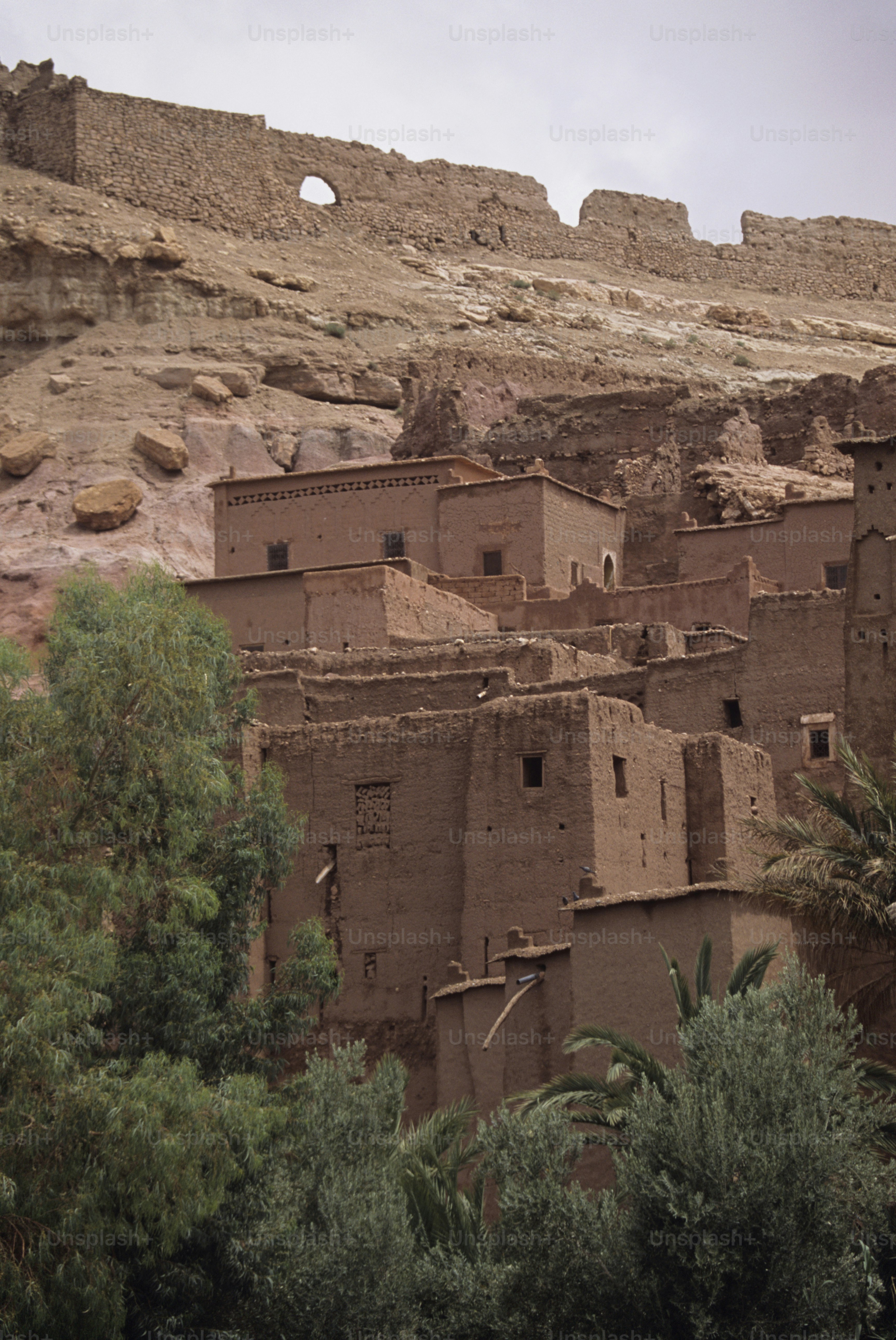 a group of adobe buildings sitting on top of a mountain