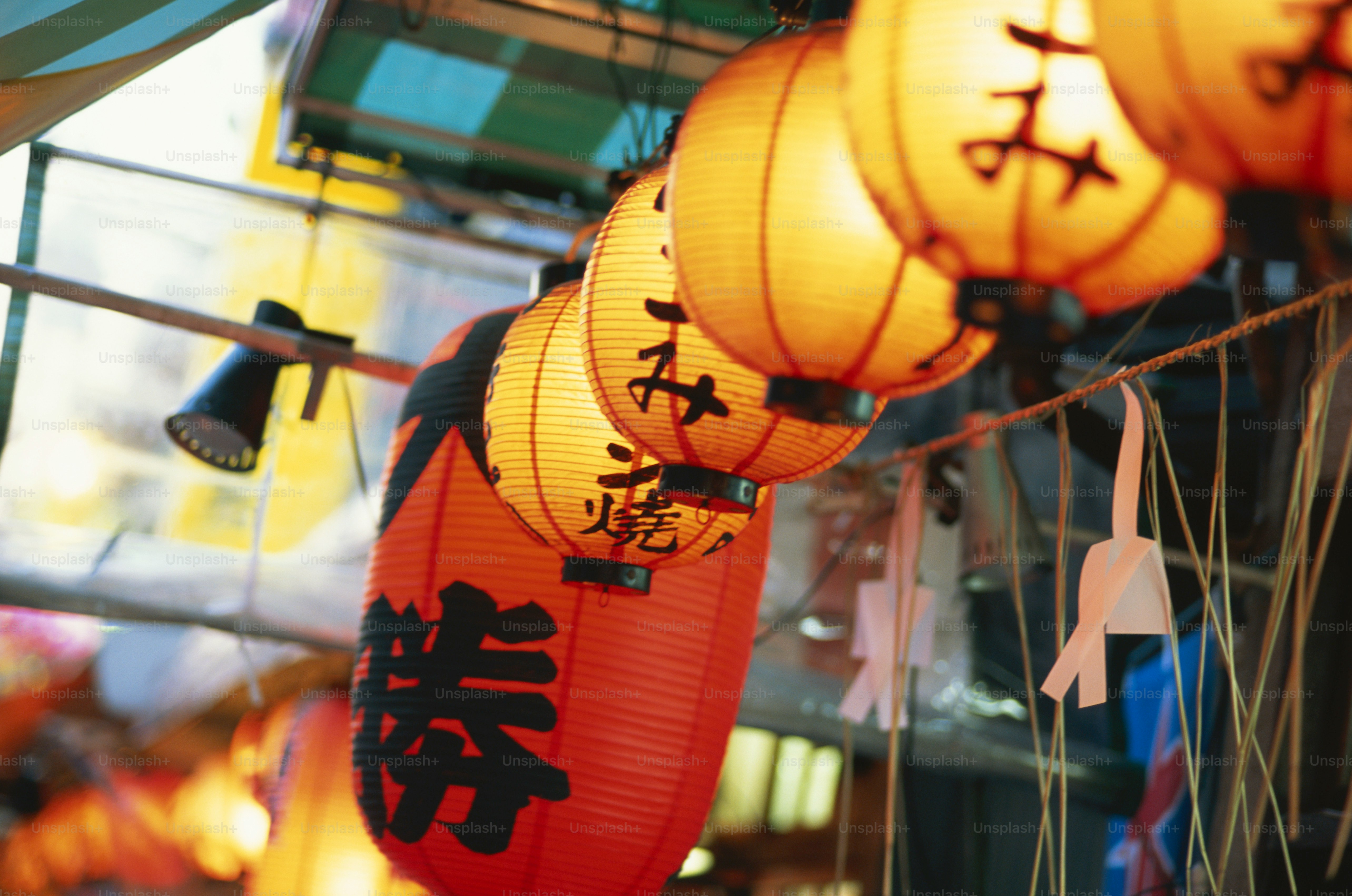 a bunch of lanterns hanging from a ceiling