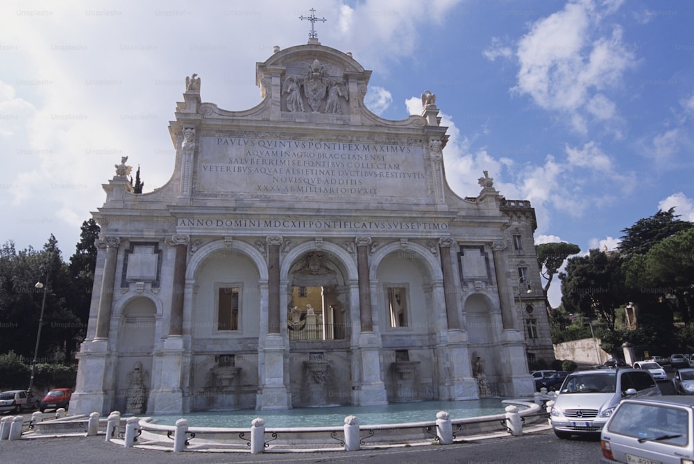 a large building with a fountain in front of it