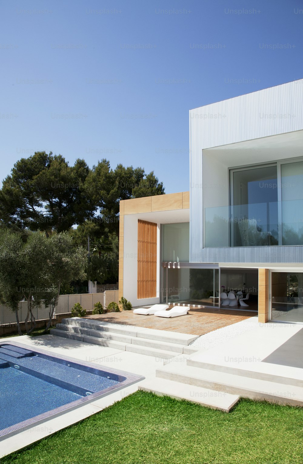 a house with a swimming pool in front of it