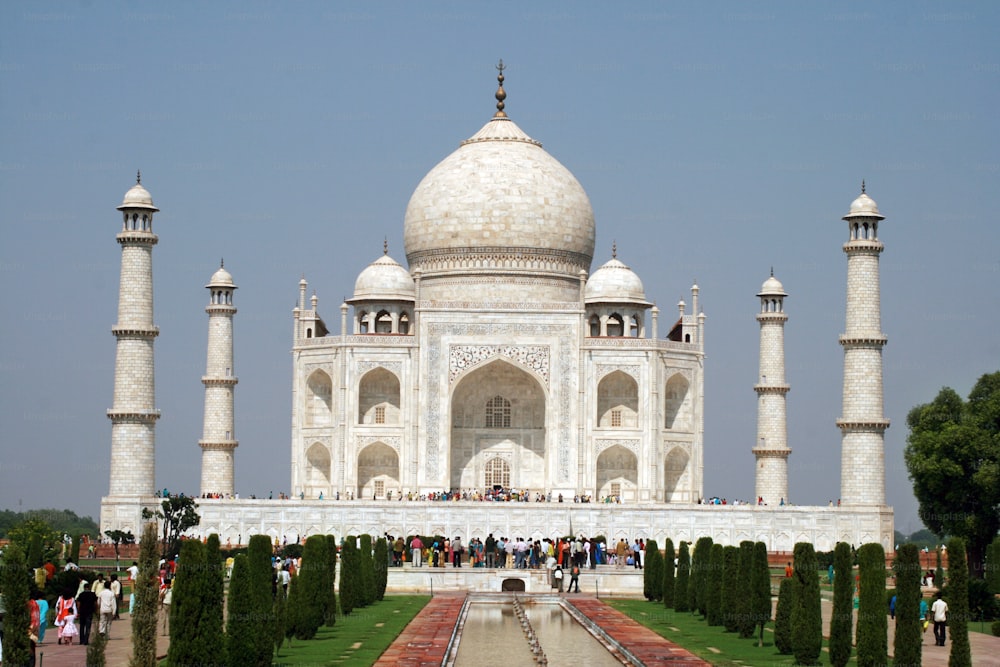 a large white building with many people standing around it