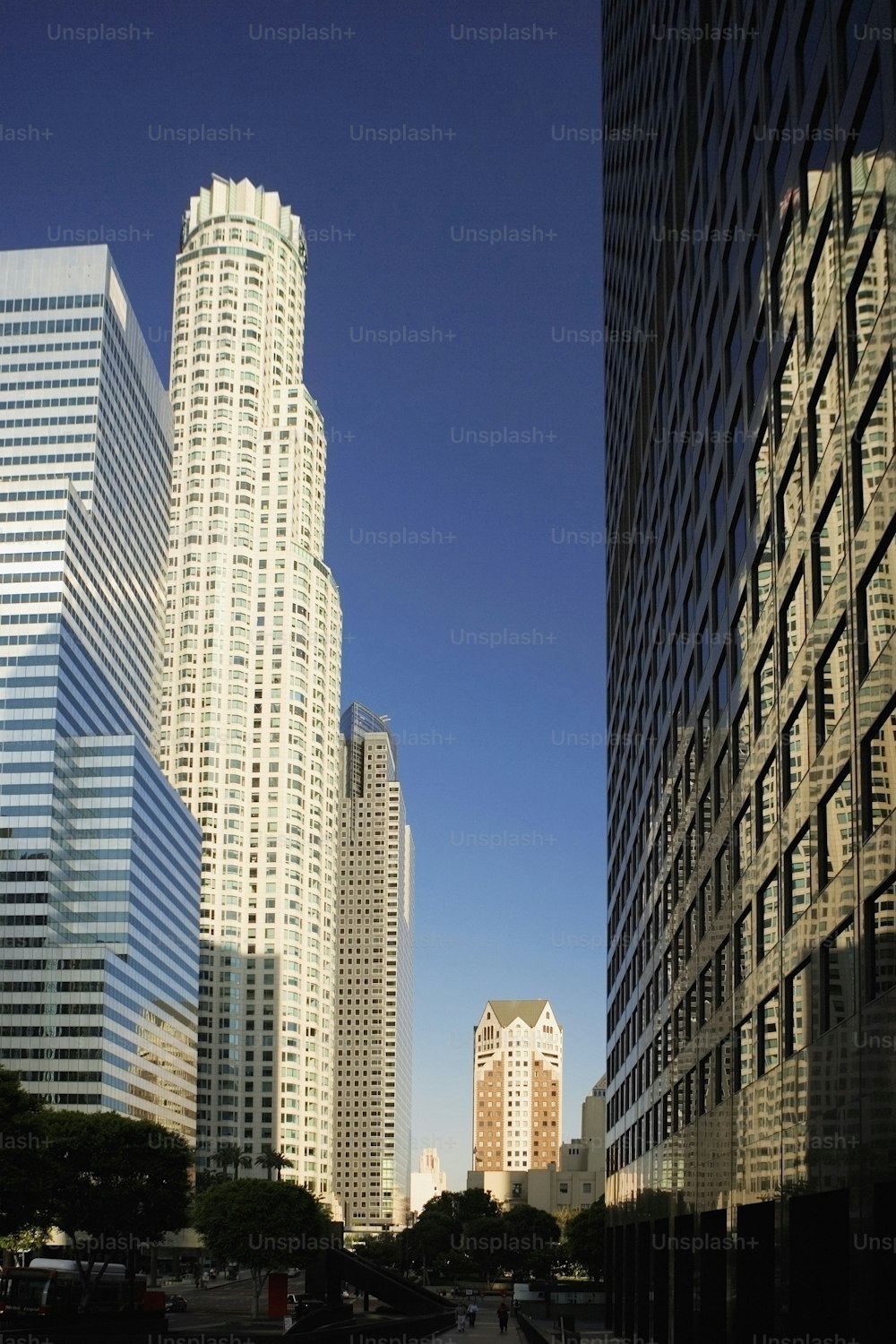 a city street with tall buildings in the background