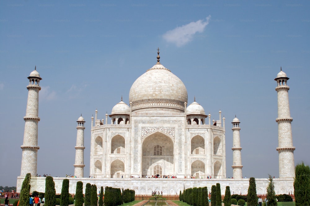 a large white building with many pillars and domes