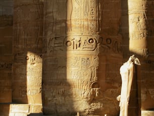 a statue in front of some very large columns