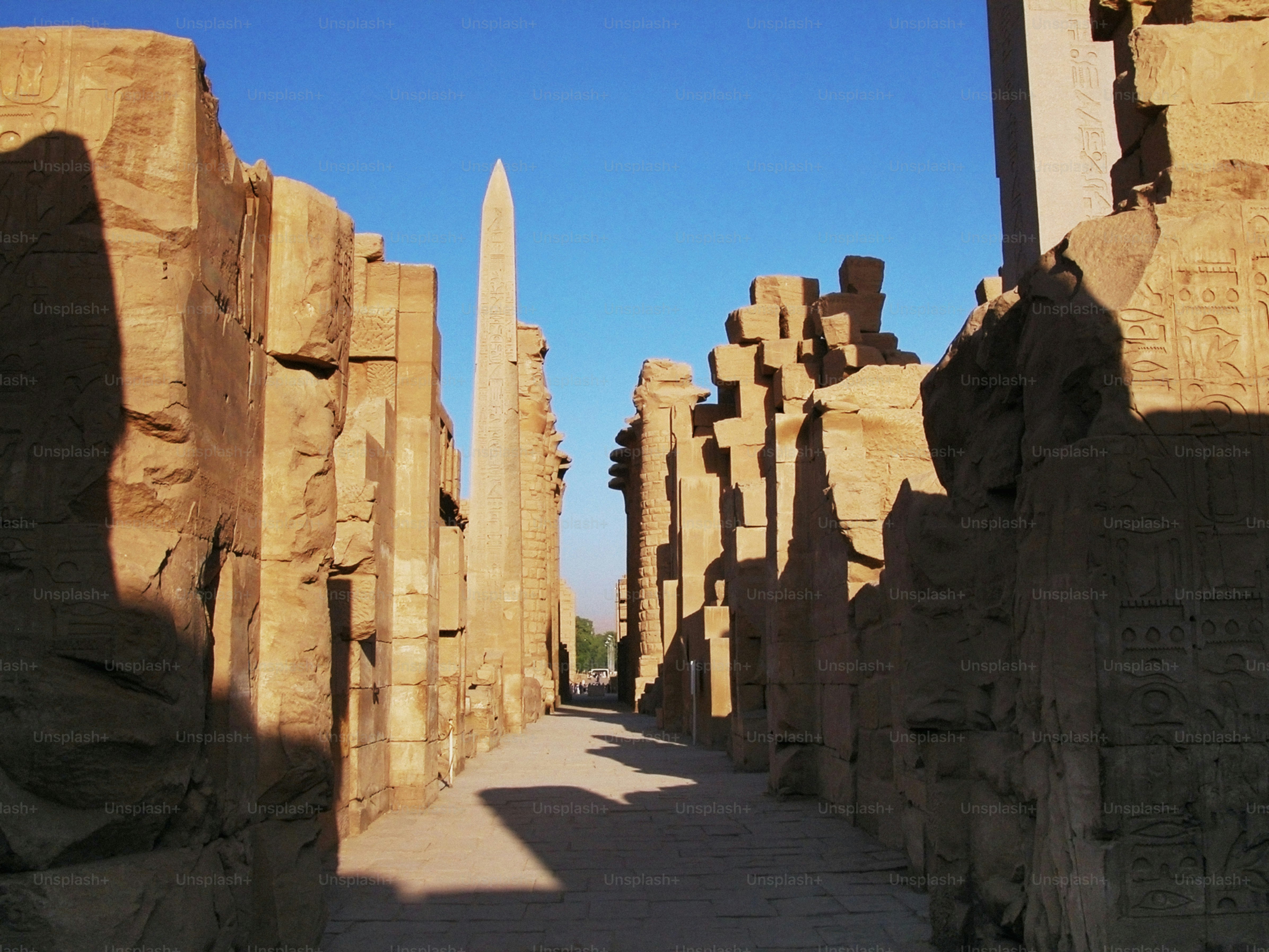 a narrow walkway between two large stone pillars