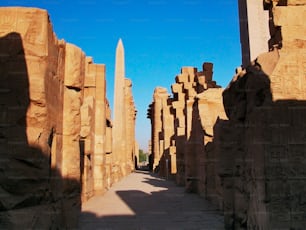 a narrow walkway between two large stone pillars