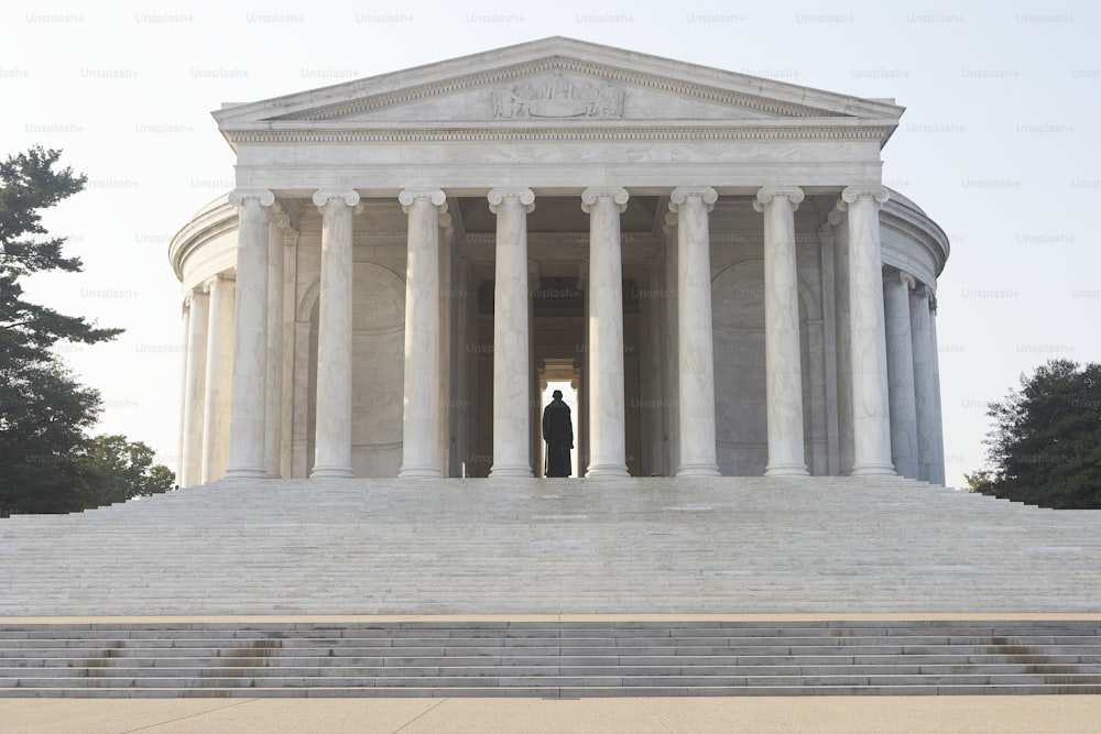 a man standing in the doorway of a monument