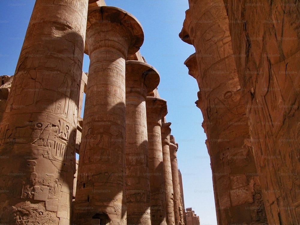 a group of large stone pillars with carvings on them