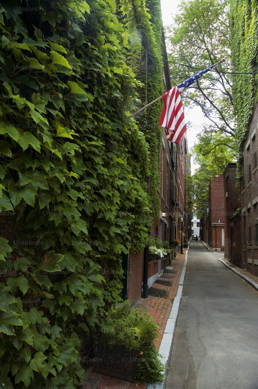 an american flag is hanging on a brick building