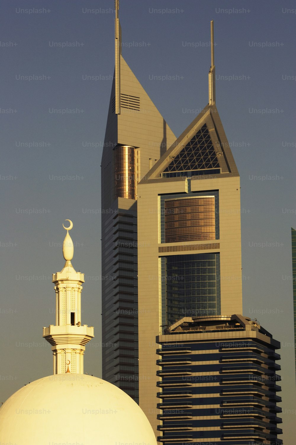 a tall building with a white dome in front of it