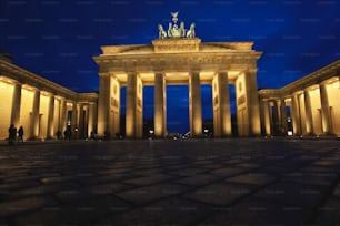a night time view of a building with columns
