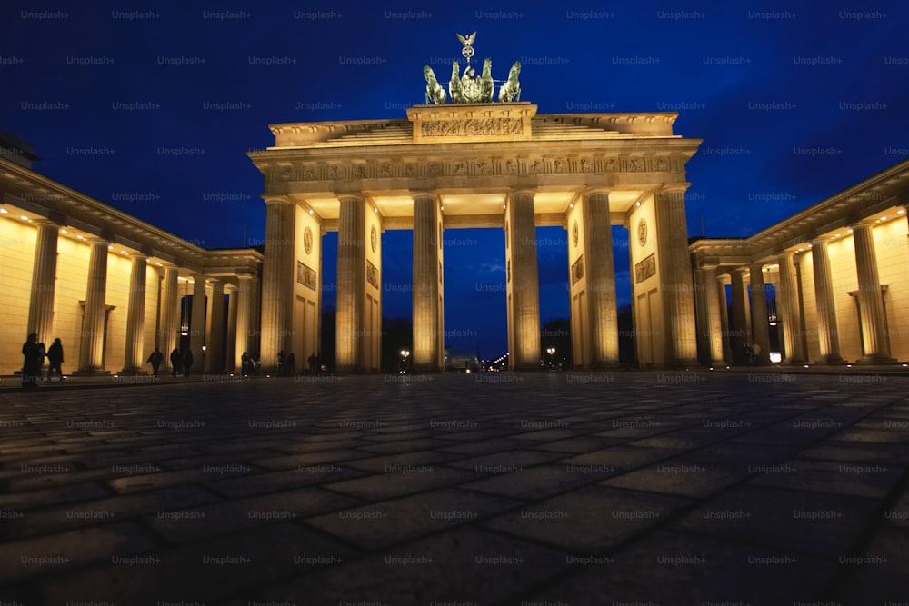 a night time view of a building with columns