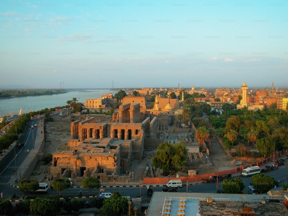 an aerial view of a city with a river in the background