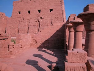 a shadow of a person standing in front of a building