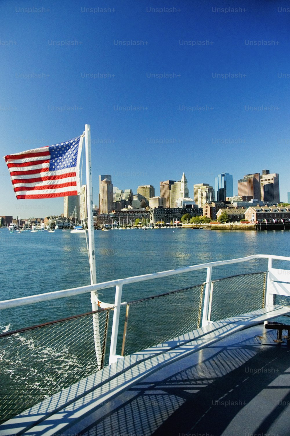 an american flag on a boat in the water