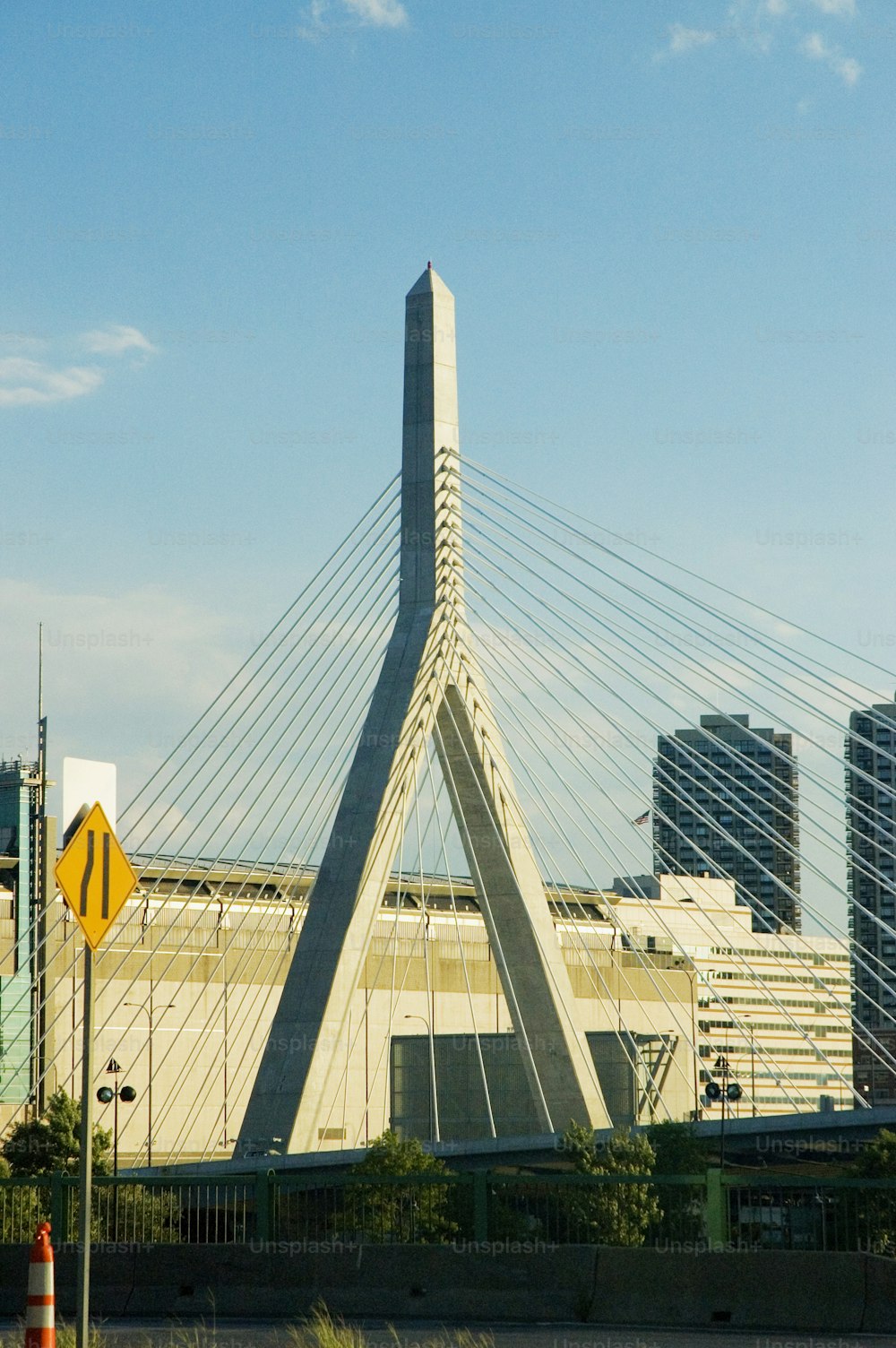 a very tall bridge with a very tall building in the background