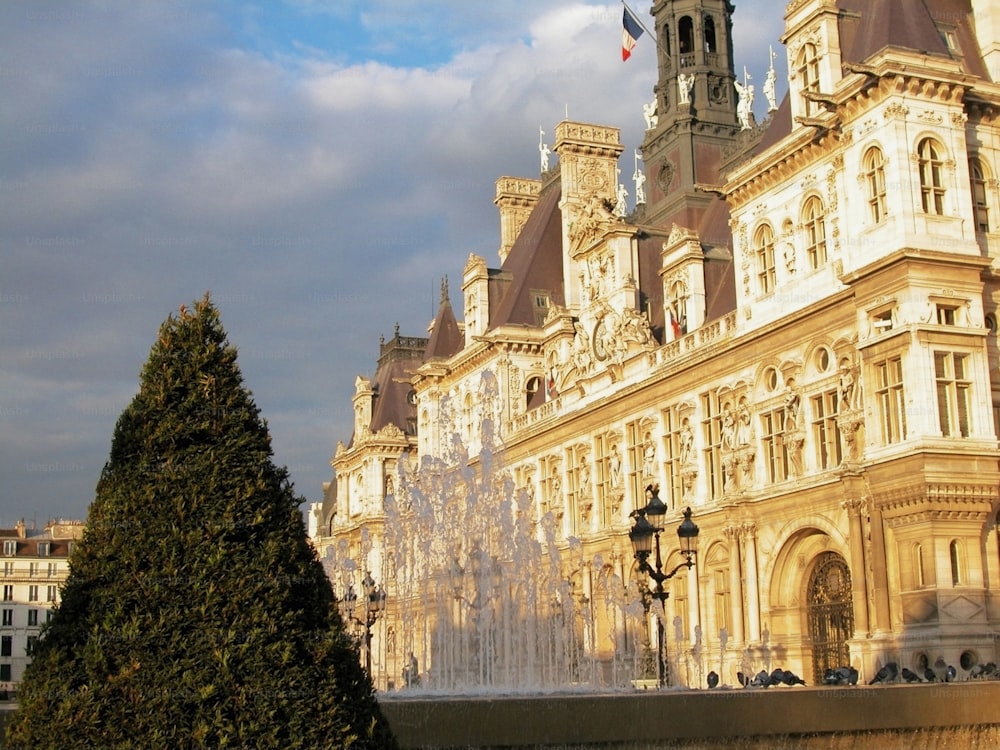 a large building with a fountain in front of it