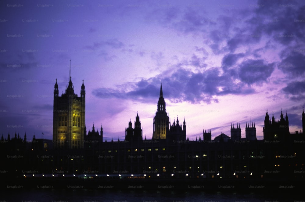 a large building with a clock tower at night