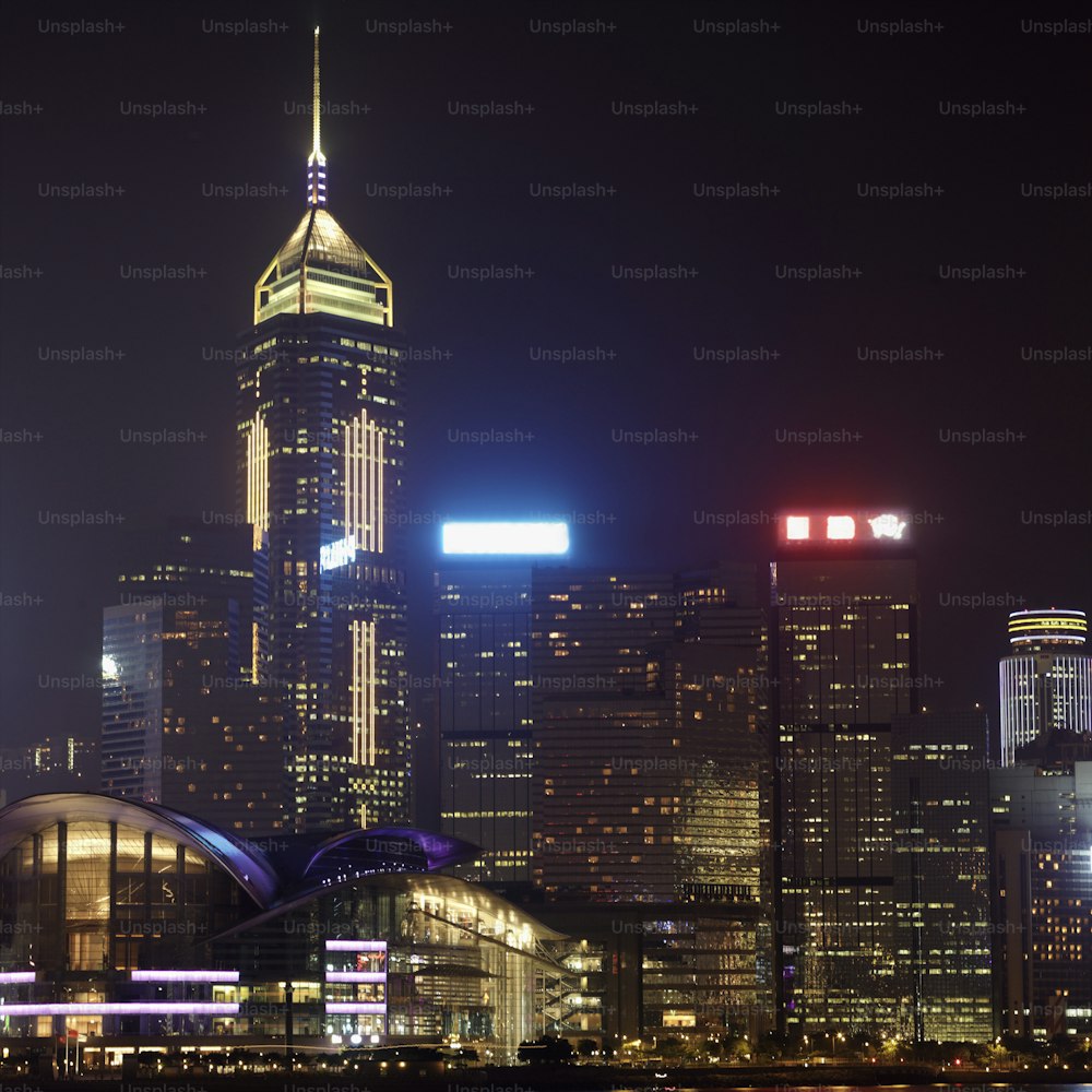 a city skyline at night with skyscrapers lit up