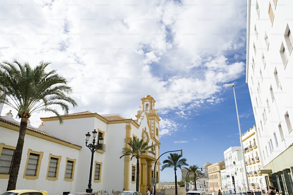 a white building with a yellow clock tower