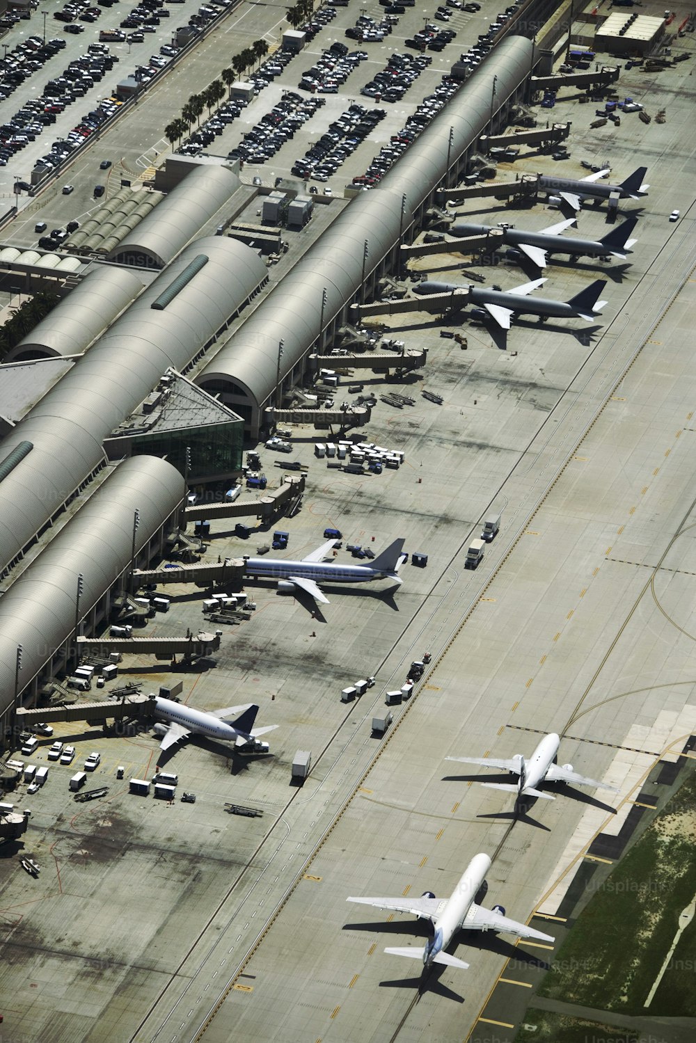 an aerial view of an airport filled with airplanes
