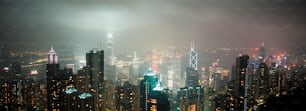 a view of a city at night from the top of a skyscraper