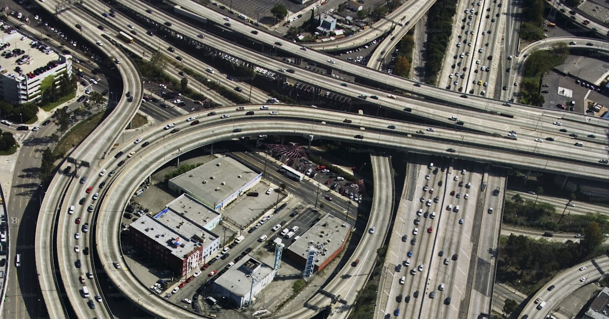 An aerial view of a highway intersection with multiple lanes photo ...