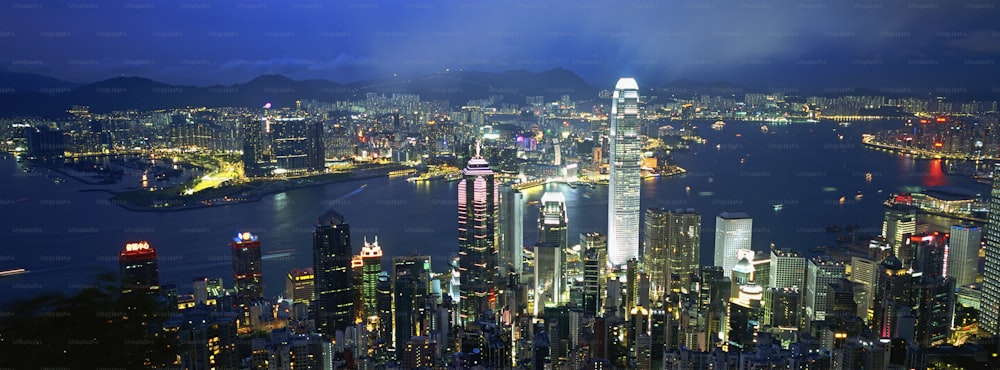 a view of a city at night from the top of a mountain