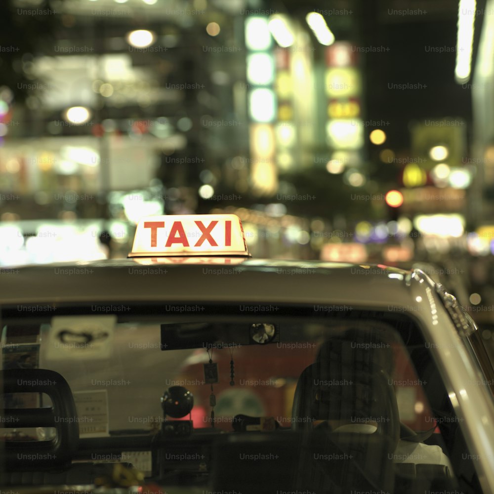 a taxi cab with a taxi sign on top of it