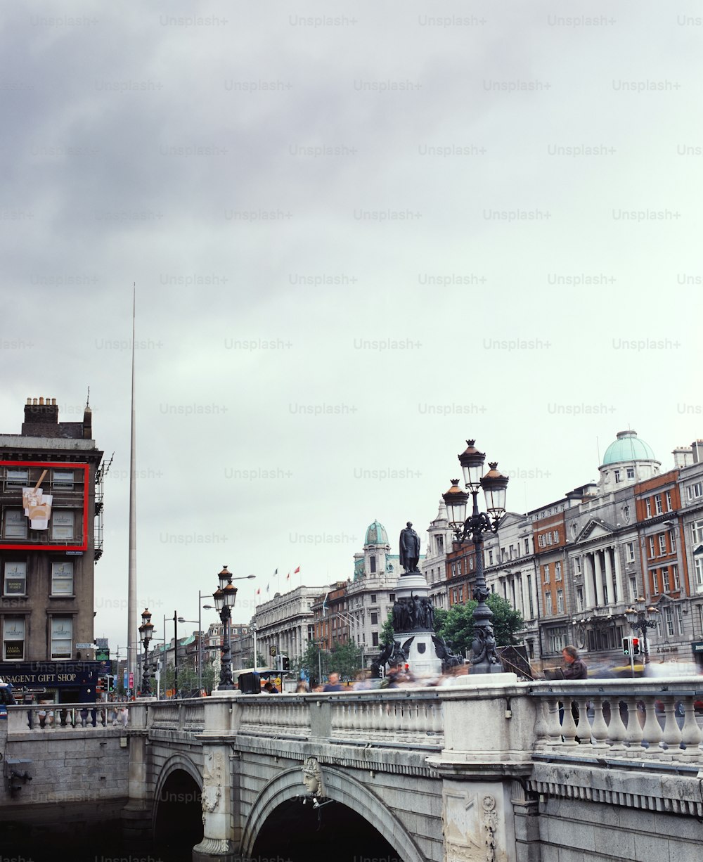 a bridge over a body of water with buildings in the background