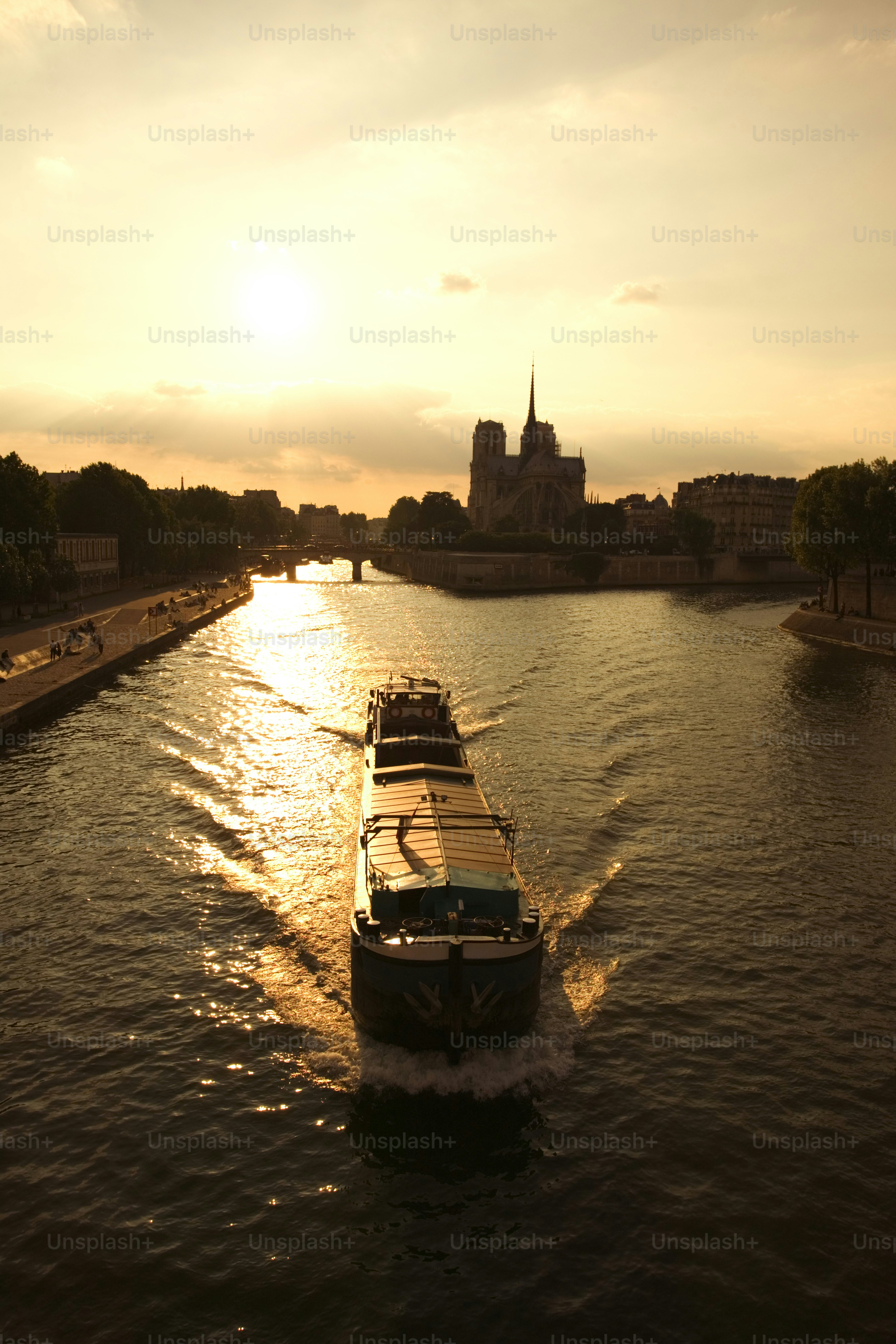 a boat traveling down a river next to a city