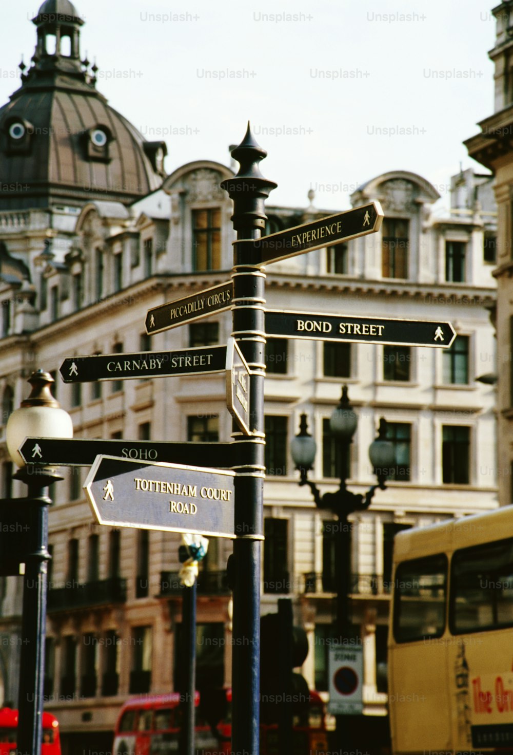 a pole with many street signs on it