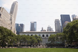a large building surrounded by tall buildings and trees