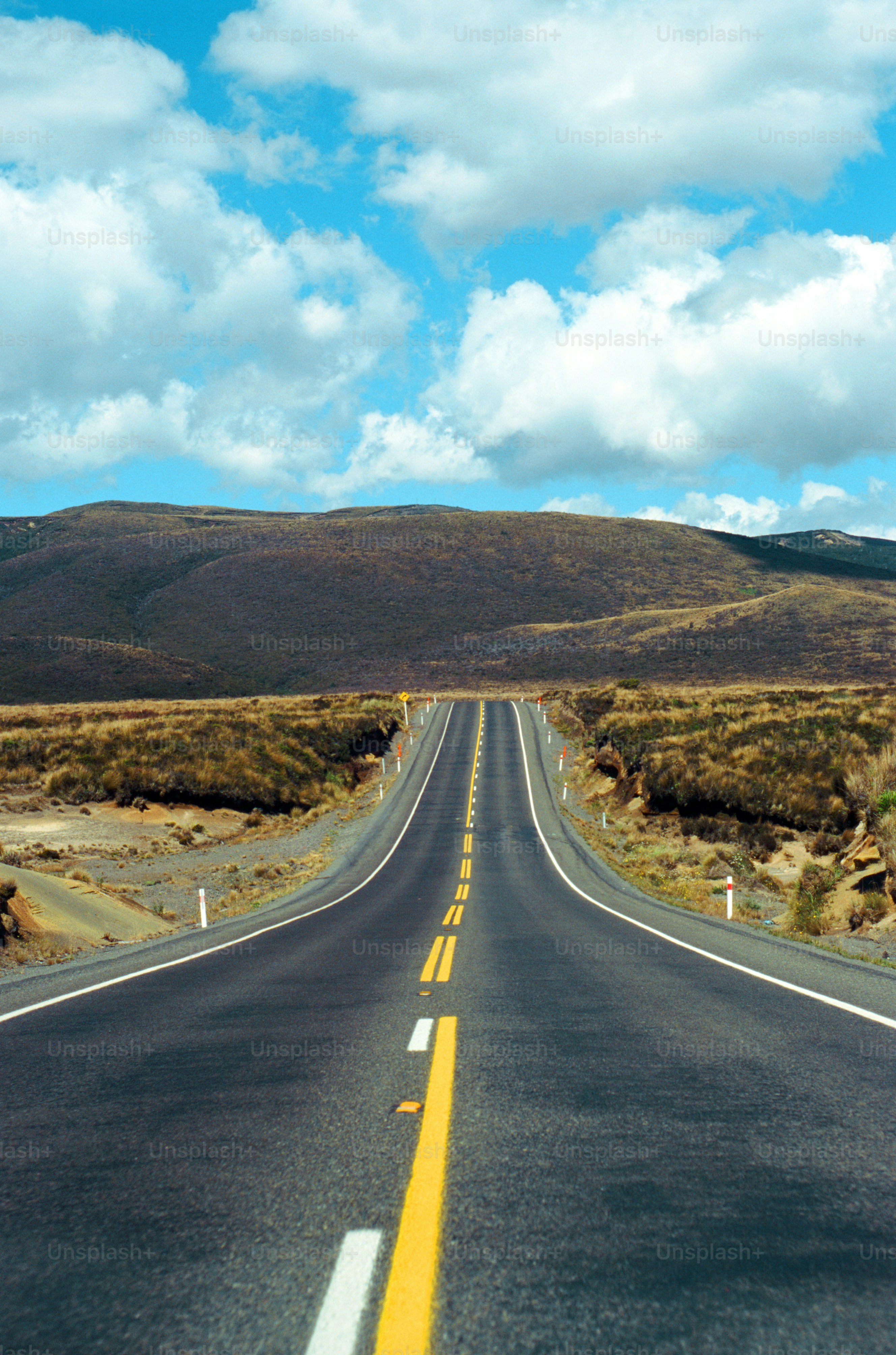 a long road with a yellow line on the side of it