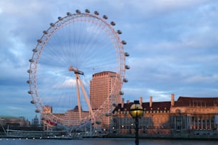 a large ferris wheel sitting next to a tall building