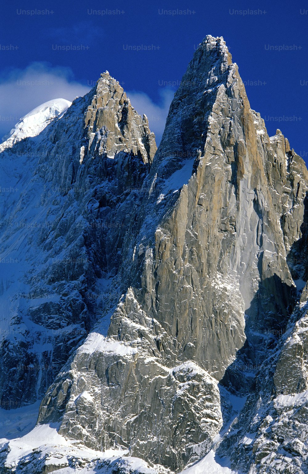 a snow covered mountain with a blue sky in the background