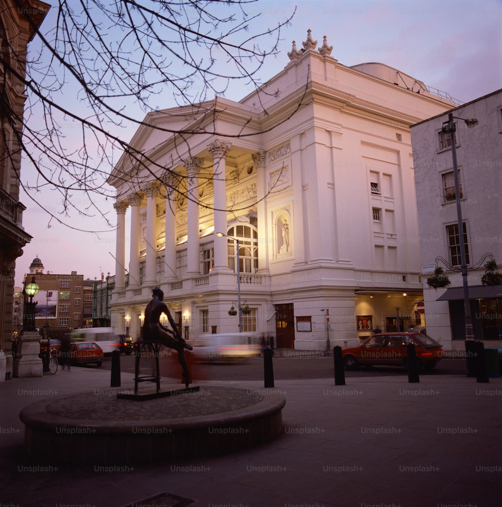 a large white building with a statue in front of it