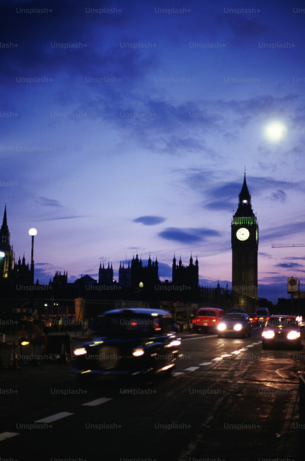 a large clock tower towering over a city at night