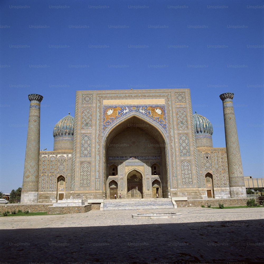 a large building with pillars and a clock on it