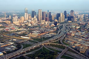 an aerial view of a city with a freeway in the foreground