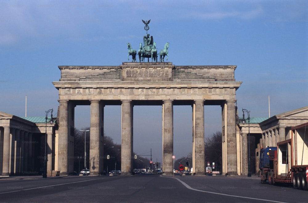 a large stone arch with a statue on top of it