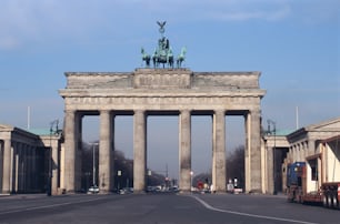 a large stone arch with a statue on top of it