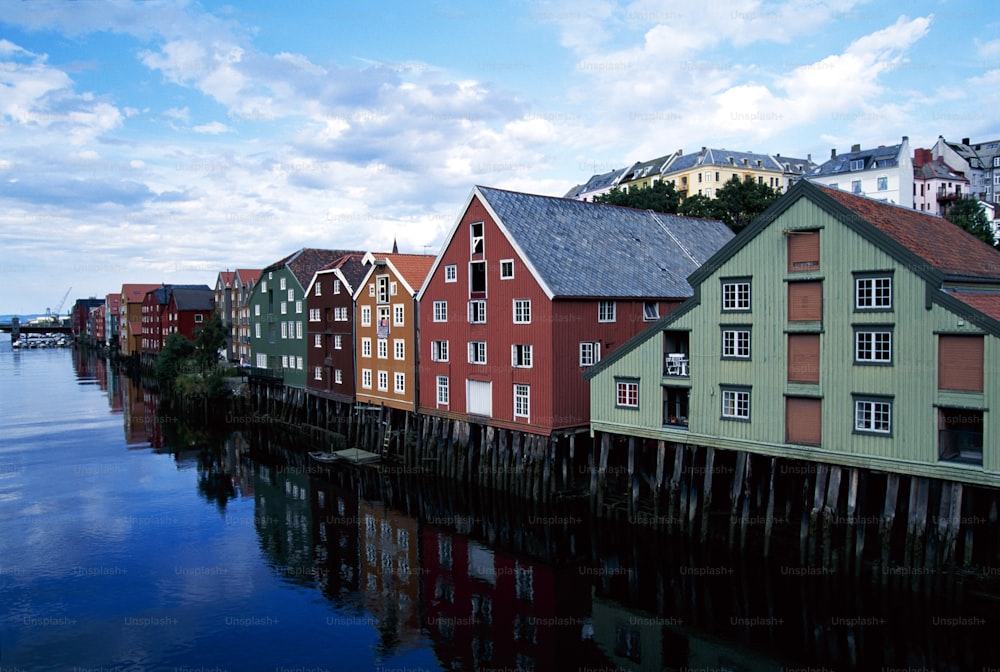 a row of houses sitting next to a body of water