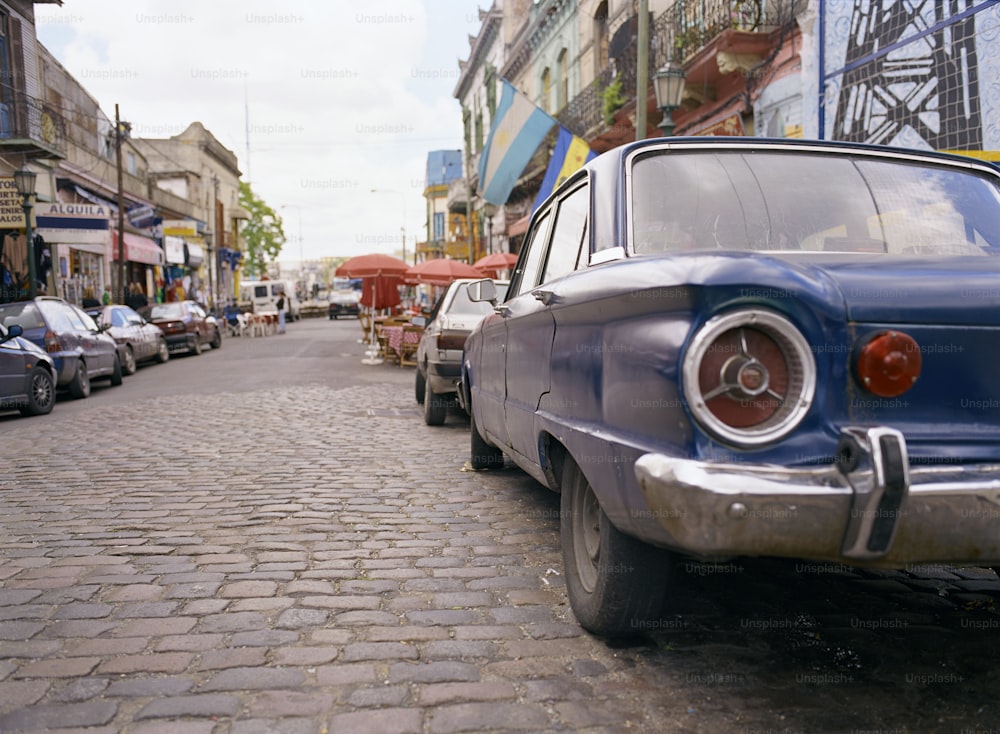 a blue car parked on the side of a street