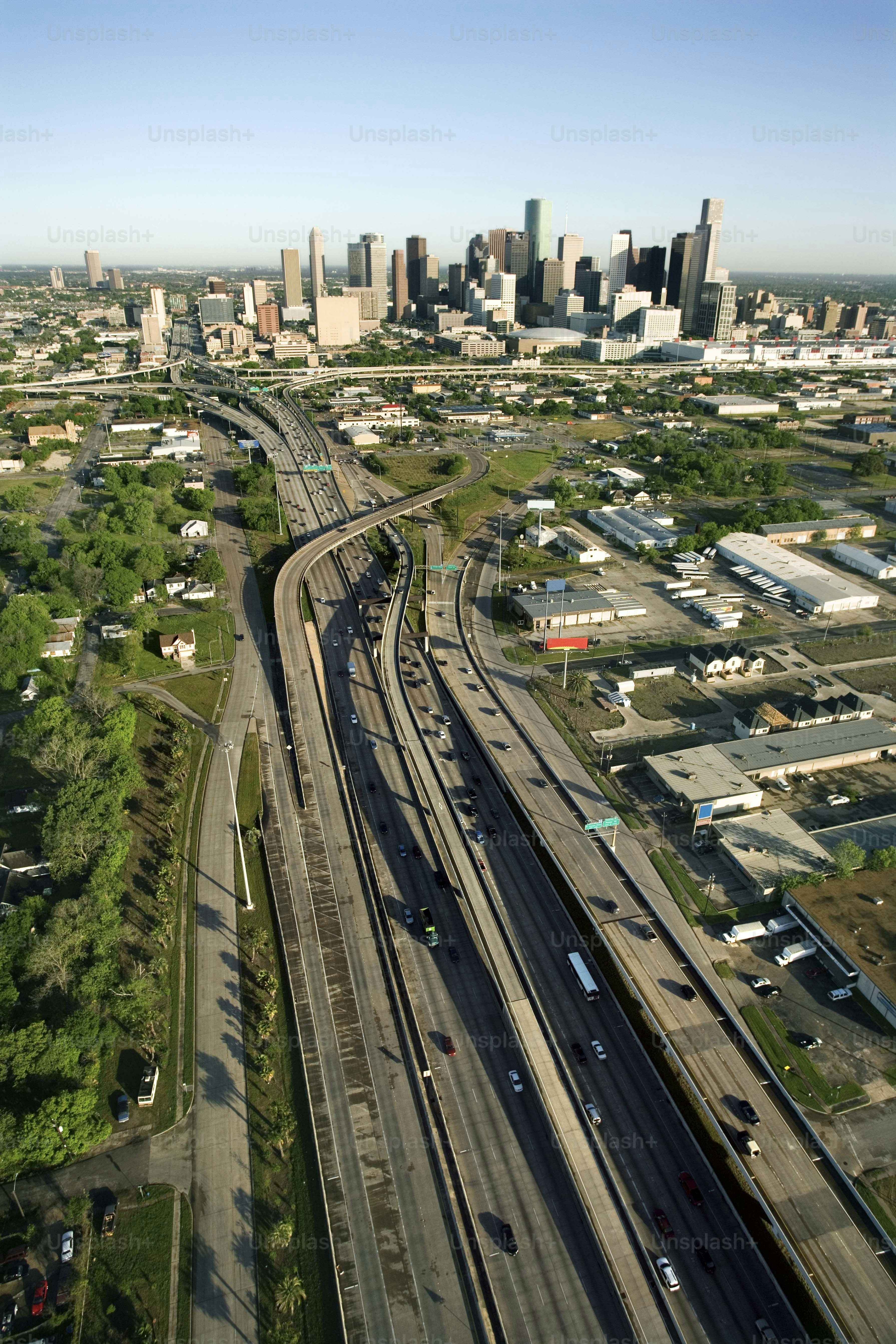 an aerial view of a city with a train on the tracks