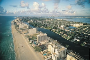 an aerial view of a city next to the ocean