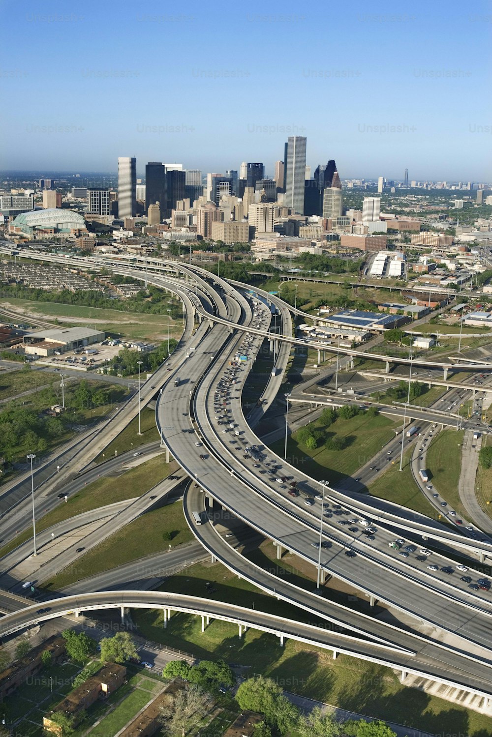 an aerial view of a freeway with a city in the background
