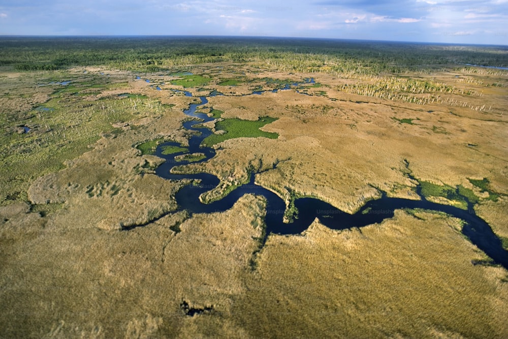 an aerial view of a river in the middle of a plain