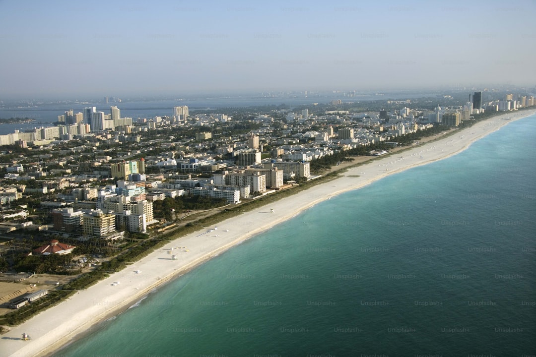 an aerial view of a city next to the ocean